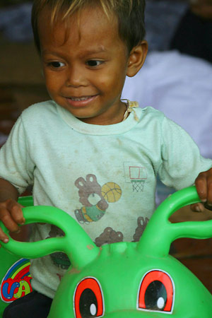 [Photo: Child with Toy]